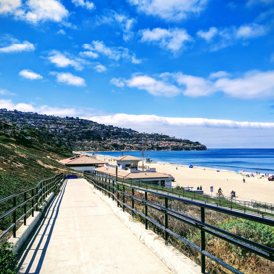 The walkway headed to the Pacific Ocean in Torrance California. Perry's Cafe is at the bottom right on the sand. Blue water, cliff views, blues sky, warm weather. Perfect.